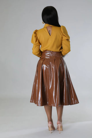 Back view of chestnut faux leather midi skirt with zipper closure