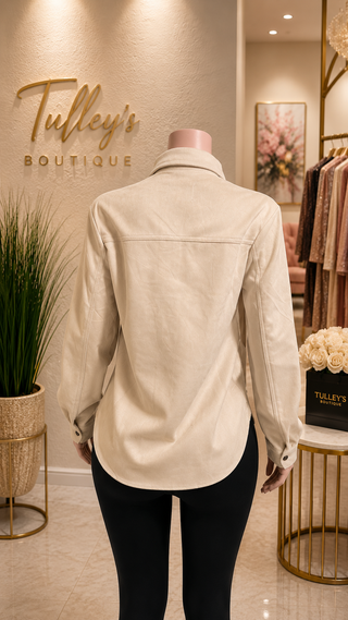 Back view of women’s cream shirt with curved hem