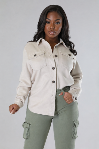 Women’s cream collared shirt styled with sage cargo pants