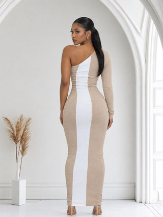 Back view of beige maxi dress with white center stripe and one-shoulder neckline