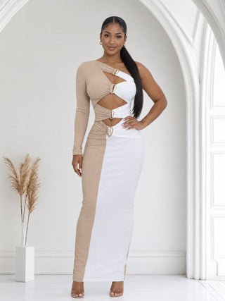 Woman in beige and white one-shoulder cutout maxi dress with gold rhinestone rings, front view