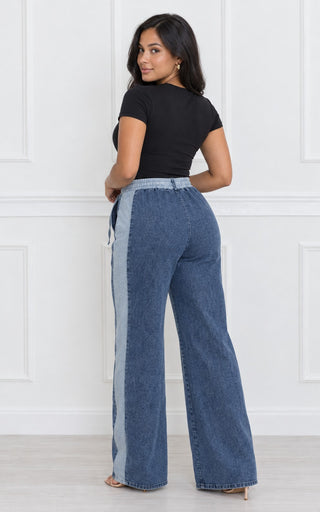 Back view of high-waisted wide-leg denim stripe pants showing the elastic waistband, seat fit and full-length wide legs