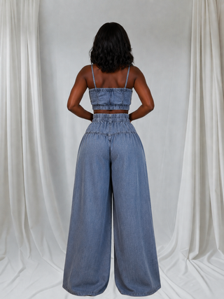 Back view of washed denim crop top and extra-baggy high-waisted wide-leg pants set