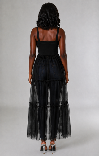 Back view of women’s sheer tiered tunic top showing wide straps, fitted waist, and layered panels