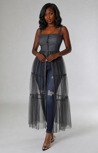 Close\-up of fitted square\-neck tunic top with button detailing and sheer fabric beginning near the navel