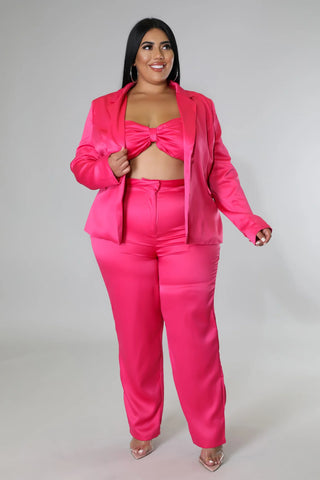 Plus size model wearing hot pink satin 3-piece pant set with blazer, tube top, and high-waisted pants – Tulley’s Boutique