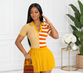 Front view of the Jan Two Face top showing the mustard polo collar, open V neckline and split chevron and stripe knit