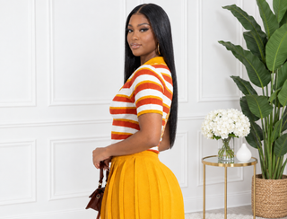 Side view of the Jan Two Face top showing the rust, white and mustard striped half and short sleeves