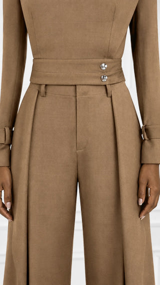 Close-up of the mocha brown set's wide waistband with silver snap buttons, buckle cuff tab and front-pleated high-waisted pants