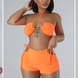 neon orange bikini set with halter crop top and swim shorts

