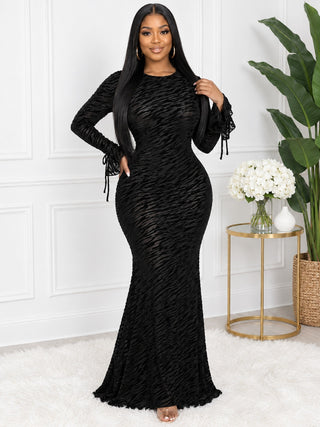 Black velvet stripe bodycon maxi dress with round neckline and mermaid hem, angled front view