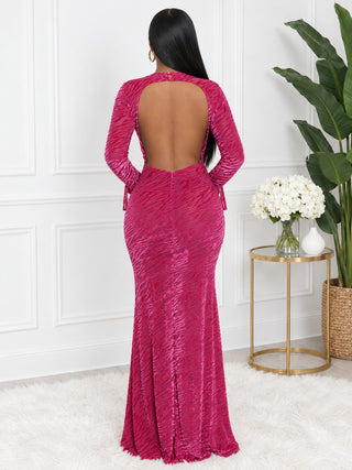 Back view of magenta pink open-back velvet maxi dress with button neck closure and center-back zipper