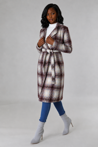 Walking pose in petite brown, cream, and beige plaid belted jacket with narrow fitted sleeves