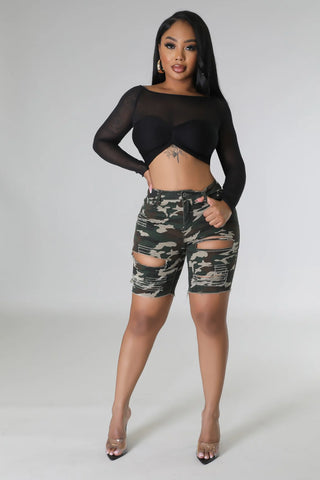 Front view of distressed camo high waisted shorts with ripped detail and button zipper closure
