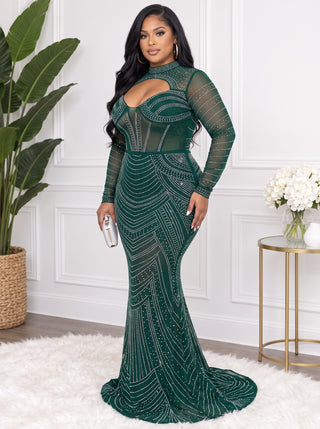 Side view of the plus size green rhinestone evening gown showing the fitted silhouette, mermaid flare and short train