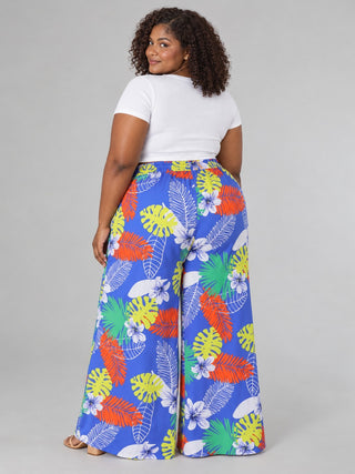 Back view of plus size tropical print wide-leg pants with smocked elastic waistband