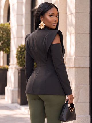 Back view of the Power Play black structured blazer showing extended shoulder panels, cold-shoulder cutout and contoured princess seams
