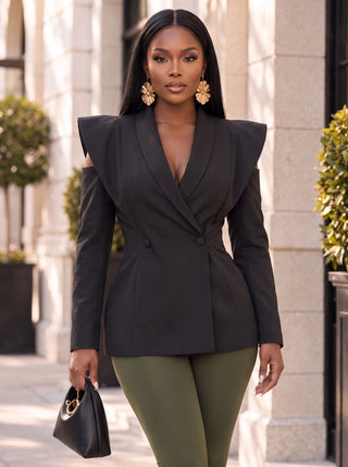 Model wearing the Power Play black cold-shoulder structured blazer with extended shoulders, deep V lapel and two-button wrap waist, styled with olive leggings, front view