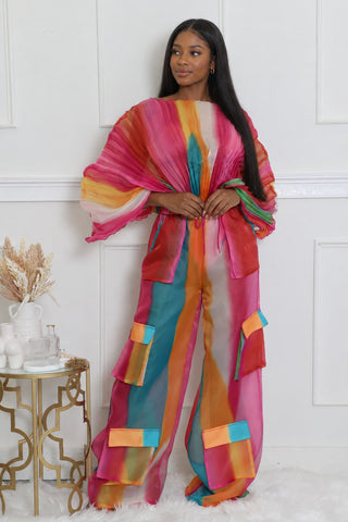 Model wearing the pink, orange and turquoise chiffon bodysuit and pants set with color-block cargo pockets