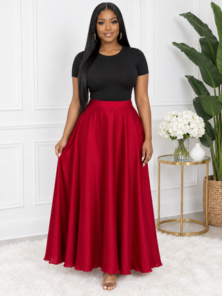 Red satin flowy maxi skirt front view on model with black bodysuit – Scarlet Sway by Tulleys Boutique