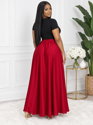 Back view of red satin maxi skirt showing elastic back waistband and full sweeping hem
