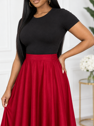Close-up of red satin maxi skirt flat front waistband, elastic back and soft sheen
