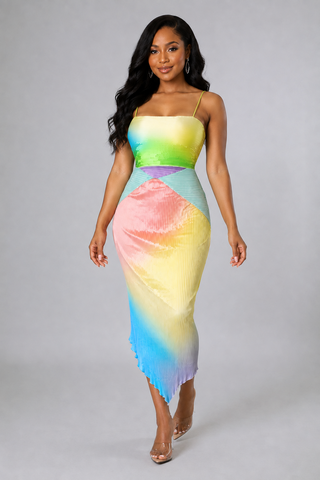 Model wearing the Sunset Sorbet multicolor pleated asymmetrical midi dress with spaghetti straps and a pastel rainbow design