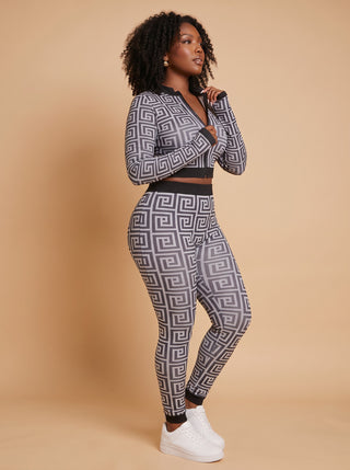 Side angle of the Greek key print zip crop top with thumbhole sleeves and high-waisted seamless leggings